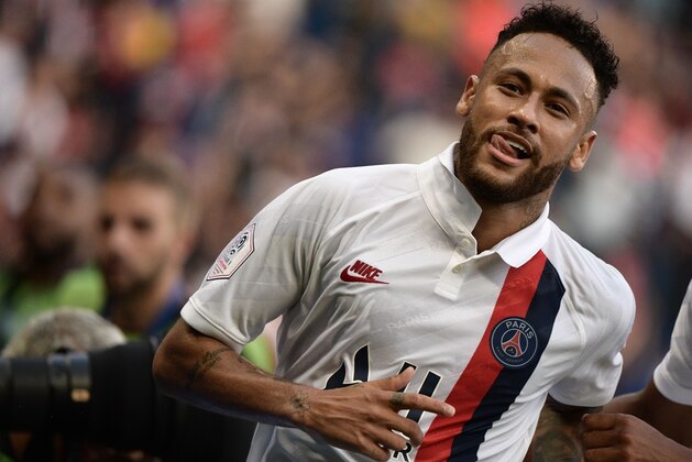 Paris Saint-Germain's Brazilian forward Neymar celebrates after scoring a goal during the French L1 football match between Paris Saint-Germain (PSG) and Racing Club de Strasbourg Alsace (RCS) on September 14, 2019 at the Parc des Princes stadium in Paris. (Photo by Martin BUREAU / AFP)        (Photo credit should read MARTIN BUREAU/AFP/Getty Images)