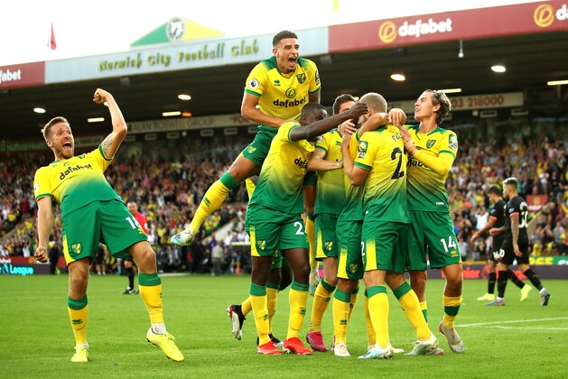 NORWICH, ENGLAND - SEPTEMBER 14: Teemu Pukki of Norwich City celebrates with teammates after scoring his team's third goal during the Premier League match between Norwich City and Manchester City at Carrow Road on September 14, 2019 in Norwich, United Kingdom. (Photo by Marc Atkins/Getty Images) NORWICH, ENGLAND - SEPTEMBER 14: Teemu Pukki of Norwich City celebrates with teammates after scoring his team's third goal during the Premier League match between Norwich City and Manchester City at Carrow Road on September 14, 2019 in Norwich, United Kingdom. (Photo by Marc Atkins/Getty Images)