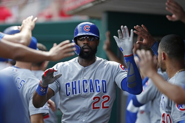 Chicago Cubs' Jason Heyward (22) is congratulated in the dugout after his three-run home run off Cincinnati Reds relief pitcher Raisel Iglesias during the ninth inning of a baseball game, Sunday, June 30, 2019, in Cincinnati. (AP Photo/Gary Landers)