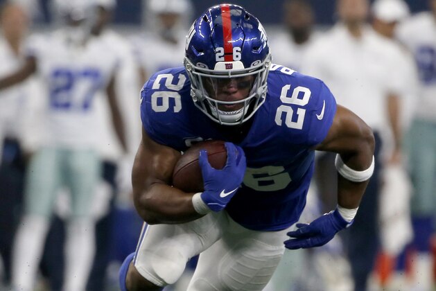 New York Giants running back Saquon Barkley (26) runs the ball against the Dallas Cowboys in the second half of a NFL football game in Arlington, Texas, Sunday, Sept. 8, 2019. (AP Photo/Michael Ainsworth)
