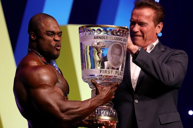 MELBOURNE, AUSTRALIA - MARCH 17:  Arnold Schwarzenegger presents winner Brandon Curry with his trophy during the 2017 Arnold Classic at The Melbourne Convention and Exhibition Centre on March 17, 2017 in Melbourne, Australia.  (Photo by Robert Cianflone/Getty Images)