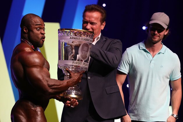 MELBOURNE, AUSTRALIA - MARCH 17:  Arnold Schwarzenegger presents winner Brandon Curry with his trophy during the 2017 Arnold Classic at The Melbourne Convention and Exhibition Centre on March 17, 2017 in Melbourne, Australia.  (Photo by Robert Cianflone/Getty Images)
