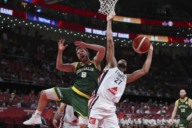 Matthew Dellavedova of Australia and Rudy Gobert of France battle the ball during their third placing match for the FIBA Basketball World Cup at the Cadillac Arena in Beijing, Saturday, Sept. 13, 2019. (AP Photo/Ng Han Guan)