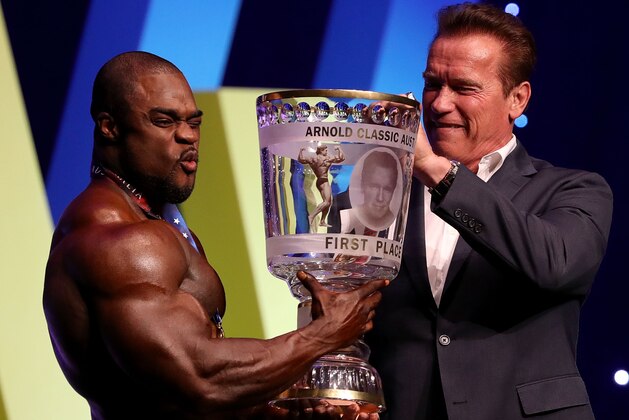 MELBOURNE, AUSTRALIA - MARCH 17:  Arnold Schwarzenegger presents winner Brandon Curry with his trophy during the 2017 Arnold Classic at The Melbourne Convention and Exhibition Centre on March 17, 2017 in Melbourne, Australia.  (Photo by Robert Cianflone/Getty Images)