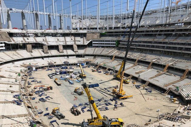 Construction workers continue work in the bowl of the NFL stadium rising in Inglewood, Calif., Tuesday, July 30, 2019. The multi-billion-dollar complex is on schedule to open in July 2020. Officials from the NFL, the Los Angeles Rams and the Los Angeles Chargers toured the stadium as part of early preparations for the Super Bowl in February 2022. (AP Photo/Greg Beacham)