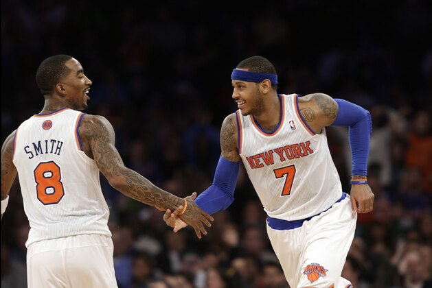 New York Knicks guard J.R. Smith (8), who scored 18 points, congratulates forward Carmelo Anthony (7) after Anthony hit a three-point shot in the second half of an NBA basketball game at Madison Square Garden in New York, Sunday, Jan. 27, 2013.  Anthony scored 42 points, including nine three-point shots as the Knicks defeated the Hawks 106-104. (AP Photo/Kathy Willens)