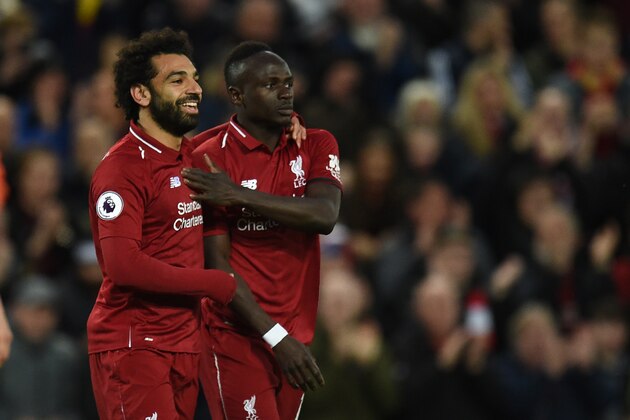 Liverpool's Senegalese striker Sadio Mane (R) celebrates with Liverpool's Egyptian midfielder Mohamed Salah after scoring the team's second goal during the English Premier League football match between Liverpool and Huddersfield at Anfield in Liverpool, north west England on April 26, 2019. (Photo by Oli SCARFF / AFP) / RESTRICTED TO EDITORIAL USE. No use with unauthorized audio, video, data, fixture lists, club/league logos or 'live' services. Online in-match use limited to 120 images. An additional 40 images may be used in extra time. No video emulation. Social media in-match use limited to 120 images. An additional 40 images may be used in extra time. No use in betting publications, games or single club/league/player publications. /         (Photo credit should read OLI SCARFF/AFP/Getty Images)