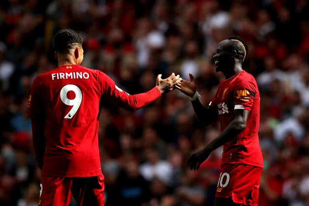 LIVERPOOL, ENGLAND - SEPTEMBER 14: Sadio Mane of Liverpool celebrates with Roberto Firmino after he scores his team's second goal during the Premier League match between Liverpool FC and Newcastle United at Anfield on September 14, 2019 in Liverpool, United Kingdom. (Photo by Jan Kruger/Getty Images)