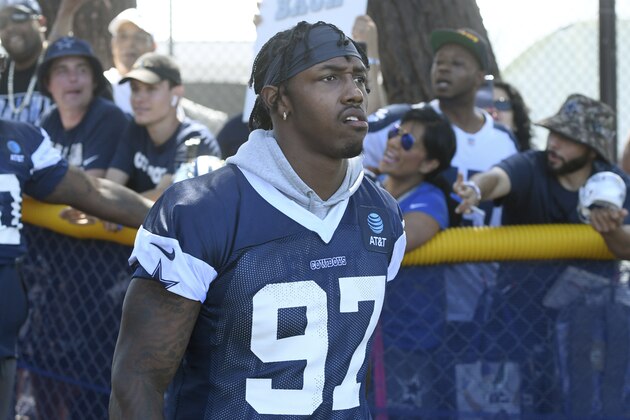 Dallas Cowboys defensive end Taco Charlton (97) walks onto the field at the NFL football team's training camp in Oxnard, Calif., Saturday, July 27, 2019. (AP Photo/Michael Owen Baker)