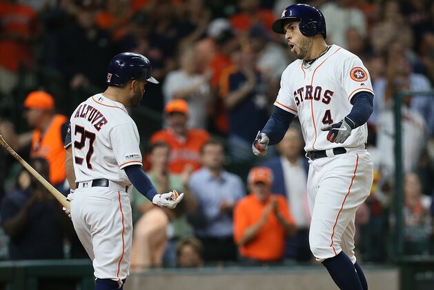 HOUSTON, TEXAS - SEPTEMBER 11: George Springer #4 of the Houston Astros celebrates with Jose Altuve #27 fter a third inning home run against the Oakland Athletics at Minute Maid Park on September 11, 2019 in Houston, Texas. (Photo by Bob Levey/Getty Images)
