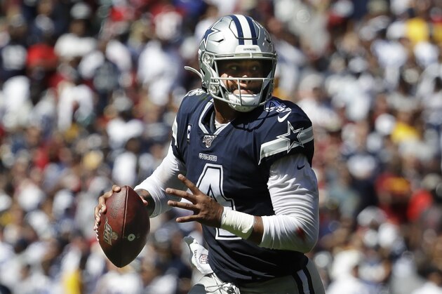Dallas Cowboys quarterback Dak Prescott (4) with the ball during first half of an NFL football game against the Washington Redskins, Sunday, Sept. 15, 2019, in Landover, Md. (AP Photo/Evan Vucci)