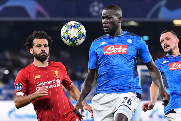 Napoli's Senegalese defender Kalidou Koulibaly (C) and Liverpool's Egyptian midfielder Mohamed Salah (L) go for the ball during the UEFA Champions League Group E football match Napoli vs Liverpool on September 17, 2019 at the San Paolo stadium in Naples. (Photo by Alberto PIZZOLI / AFP)        (Photo credit should read ALBERTO PIZZOLI/AFP/Getty Images)