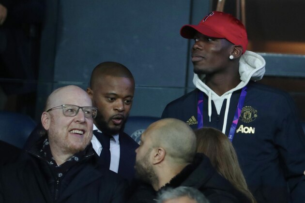 PARIS, FRANCE - MARCH 06:  Patrice Evra and Paul Pogba of Manchester United attend the UEFA Champions League Round of 16 Second Leg match between Paris Saint-Germain (PSG) and Manchester United at Parc des Princes on March 6, 2019 in Paris.  (Photo by Xavier Laine/Getty Images)