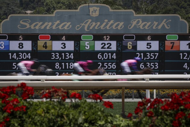Horses finish the the first race during the last day of the winter/spring meet at the Santa Anita horse racing track Sunday, June 23, 2019, in Santa Anita, Calif. (AP Photo/Chris Carlson)