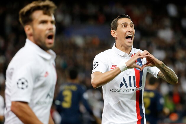 Paris Saint-Germain's Argentine midfielder Angel Di Maria (R) celebrates scoring his team's first goal during the UEFA Champions league Group A football match between Paris Saint-Germain and Real Madrid, at the Parc des Princes stadium, in Paris, on September 18, 2019. (Photo by Thomas SAMSON / AFP)        (Photo credit should read THOMAS SAMSON/AFP/Getty Images)