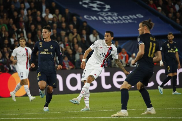 PSG's Angel Di Maria, center, scores his side's second goal during the Champions League group A soccer match between PSG and Real Madrid at the Parc des Princes stadium in Paris, Wednesday, Sept. 18, 2019. (AP Photo/Francois Mori)