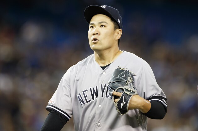 TORONTO, ON - SEPTEMBER 13: Masahiro Tanaka #19 of the New York Yankees walks back to the dugout at the end of the fourth inning of their MLB game against the Toronto Blue Jays at Rogers Centre on September 13, 2019 in Toronto, Canada. (Photo by Cole Burston/Getty Images)