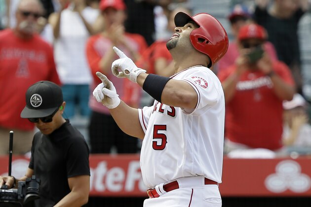 Los Angeles Angels designated hitter Albert Pujols points to the sky after hitting a three-run home run against the Tampa Bay Rays during the fifth inning of a baseball game in Anaheim, Calif., Sunday, Sept. 15, 2019. (AP Photo/Alex Gallardo)
