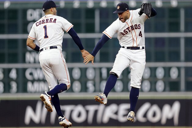 HOUSTON, TEXAS - SEPTEMBER 17: Carlos Correa #1 of the Houston Astros and George Springer #4 celebrate after the final out against the Texas Rangers at Minute Maid Park on September 17, 2019 in Houston, Texas. (Photo by Bob Levey/Getty Images)