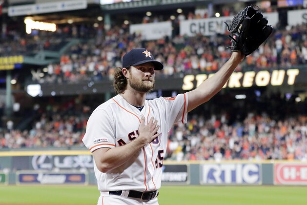 Houston Astros starting pitcher Gerrit Cole waves to the crowd as he leaves the mound after striking out Texas Rangers designated hitter Shin-Soo Choo for his 300th season strikeout during the sixth inning of a baseball game Wednesday, Sept. 18, 2019, in Houston. (AP Photo/Michael Wyke)