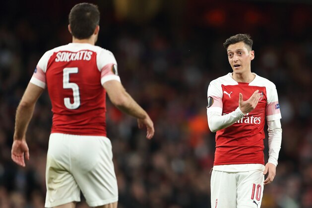 LONDON, ENGLAND - MAY 02: Mesut Ozil of Arsenal in discussion with Sokratis Papastathopoulos during the UEFA Europa League Semi Final First Leg match between Arsenal and Valencia at Emirates Stadium on May 2, 2019 in London, England. (Photo by James Williamson - AMA/Getty Images)