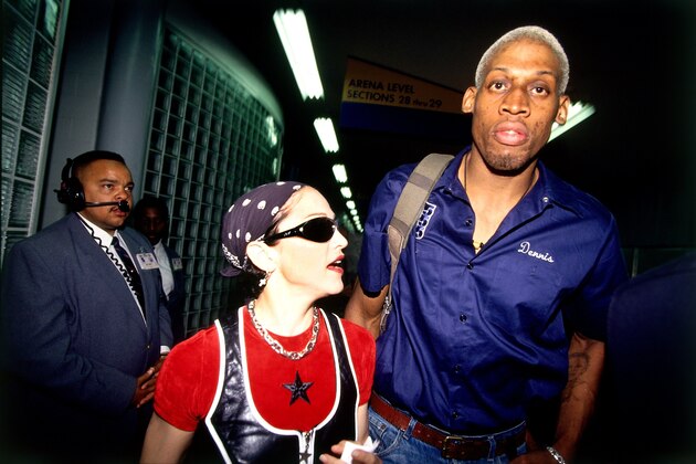 USA - 1994:  Dennis Rodman #10 of the San Antonio Spurs and Madonna strolls through the arena before a 1994 NBA game. NOTE TO USER: User expressly acknowledges that, by downloading and or using this photograph, User is consenting to the terms and conditions of the Getty Images License agreement. Mandatory Copyright Notice: Copyright 1994 NBAE (Photo by Andrew D. Bernstein/NBAE via Getty Images)