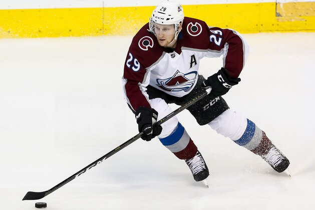 Colorado Avalanche center Nathan MacKinnon (29) skates with the puck during the third period of an NHL hockey game against the Dallas Stars in Dallas, Thursday, March 21, 2019. (AP Photo/Sam Hodde)