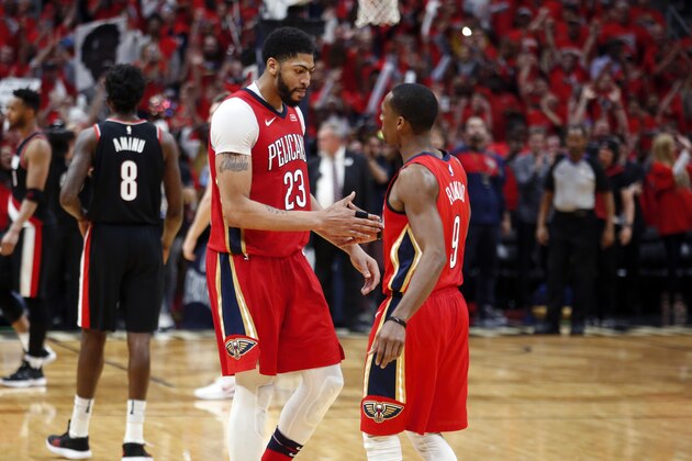 New Orleans Pelicans forward Anthony Davis (23) celebrates with guard Rajon Rondo (9) after defeating the Portland Trail Blazers in Game 4 of a first-round NBA basketball playoff series in New Orleans, Saturday, April 21, 2018. The Pelicans won 131-123 to sweep the series. (AP Photo/Scott Threlkeld)