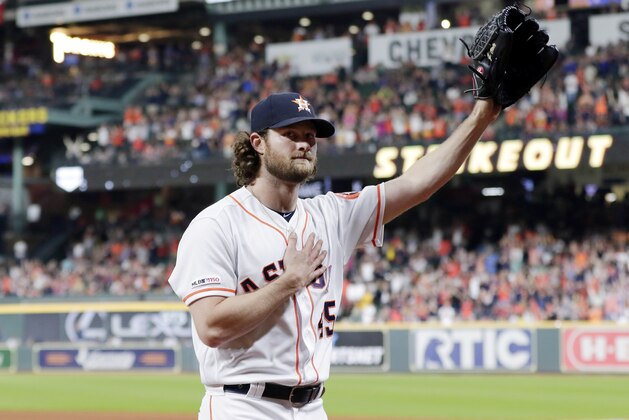 Houston Astros starting pitcher Gerrit Cole waves to the crowd as he leaves the mound after striking out Texas Rangers designated hitter Shin-Soo Choo for his 300th season strikeout during the sixth inning of a baseball game Wednesday, Sept. 18, 2019, in Houston. (AP Photo/Michael Wyke)
