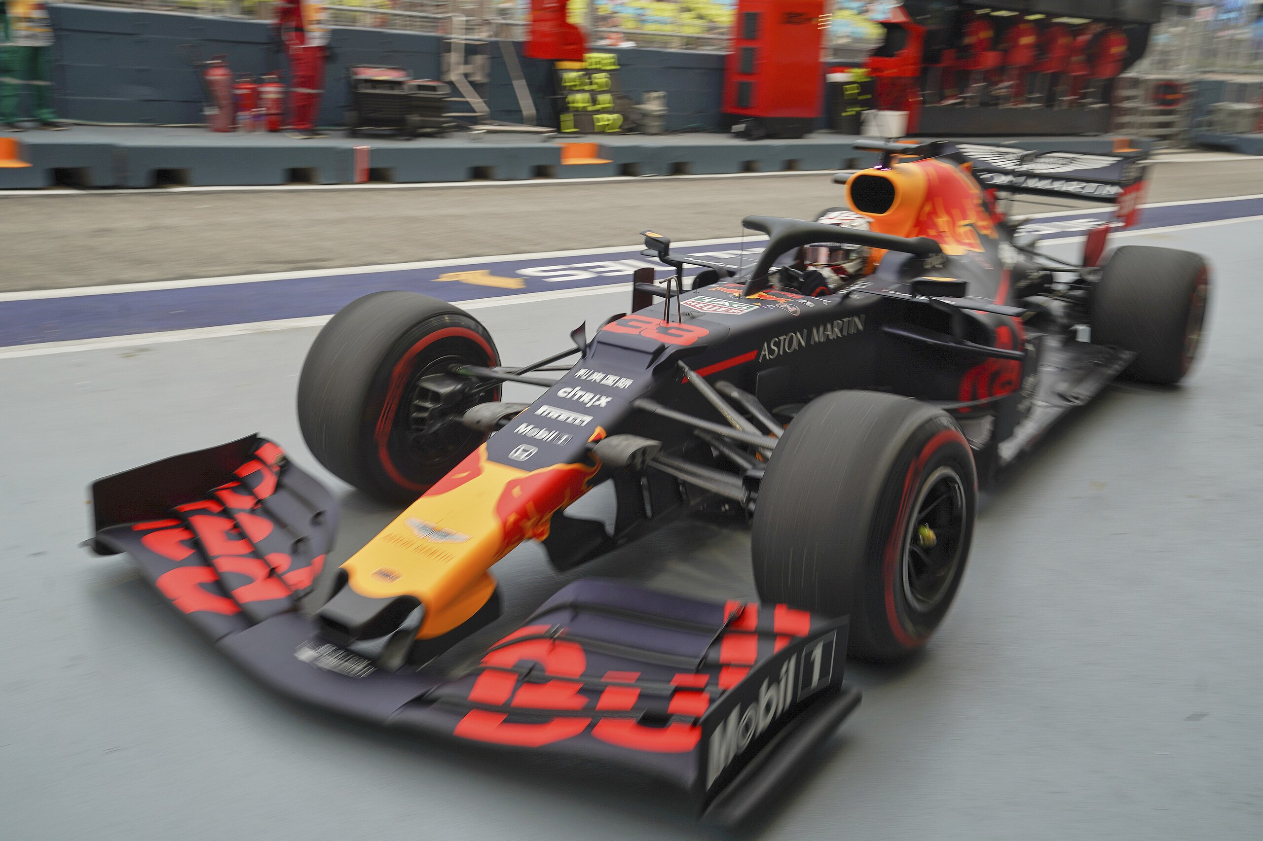 Red Bull driver Max Verstappen of the Netherlands returns to his team garage during the first practice session at the Marina Bay City Circuit ahead of the Singapore Formula One Grand Prix in Singapore, Friday, Sept. 20, 2019. (AP Photo/Vincent Thian)