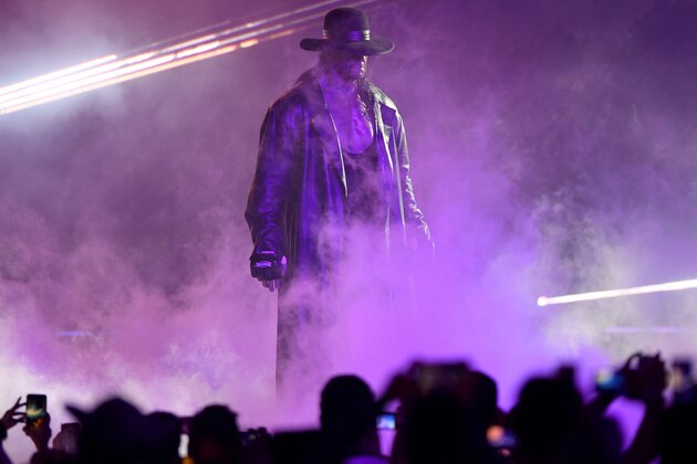 TOPSHOT - World Wrestling Entertainment star The Undertaker makes his way to the ring during a match at the World Wrestling Entertainment (WWE) Super Showdown event in the Saudi Red Sea port city of Jeddah late on January 7, 2019. (Photo by Amer HILABI / AFP)        (Photo credit should read AMER HILABI/AFP/Getty Images)