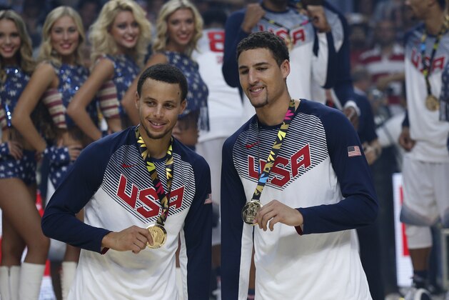 FILE - In this Sept. 14, 2014, file photo, United States' Stephen Curry, left, and Klay Thompson celebrate after wining the final World Basketball match against Serbia at the Palacio de los Deportes stadium in Madrid, Spain. Curry has withdrawn from consideration from the Olympics, leaving the U.S. basketball team without the NBA's MVP. Curry says Monday, June 6, 2016, in a statement that he has decided to pull out for