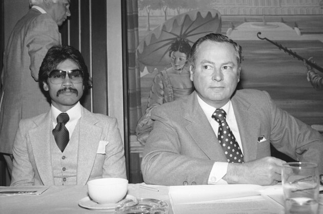 Barron Hilton (right) announced that Carlos Palomino, shown with him at press conference in Los Angeles on Thursday, Dec. 15, 1977, will defend his world welterweight title on February 11th, against challenger Ryu Sorimachi, Japanese welterweight champion. The fifteen round bout will be carried live from the Las Vegas Hilton. (AP Photo/Nick Ut)