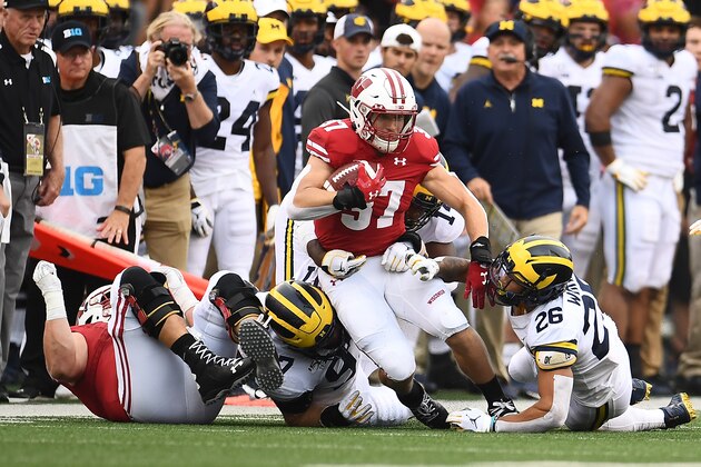 MADISON, WISCONSIN - SEPTEMBER 21:  Garrett Groshek #37 of the Wisconsin Badgers is brought down by J'Marick Woods #26 of the Michigan Wolverines during the first half at Camp Randall Stadium on September 21, 2019 in Madison, Wisconsin. (Photo by Stacy Revere/Getty Images)