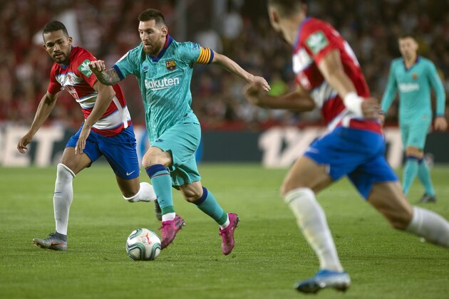 Granada's Venezuelan midfielder Yangel Herrera (L) vies with Barcelona's Argentinian forward Lionel Messi during the Spanish league football match between Granada FC and FC Barcelona at Nuevo Los Carmenes stadium in Granada on September 21, 2019. (Photo by JORGE GUERRERO / AFP)        (Photo credit should read JORGE GUERRERO/AFP/Getty Images)