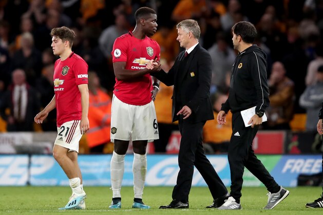 WOLVERHAMPTON, ENGLAND - AUGUST 19: Paul Pogba of Manchester United reacts alongside Ole Gunnar Solskjaer manager of Manchester United at full time during the Premier League match between Wolverhampton Wanderers and Manchester United at Molineux on August 19, 2019 in Wolverhampton, United Kingdom. (Photo by Marc Atkins/Getty Images)