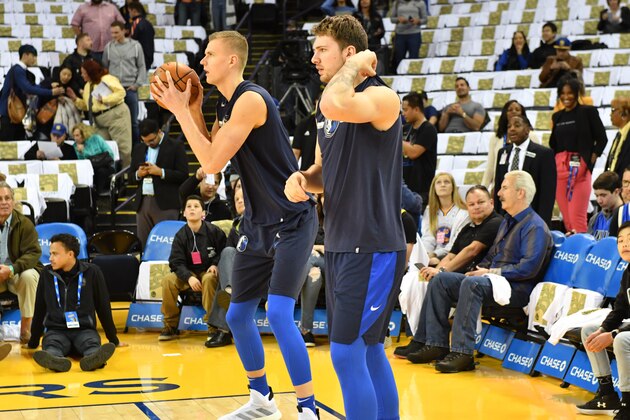 OAKLAND, CA - MARCH 23: Kristaps Porzingis #6 and Luka Doncic #77 of the Dallas Mavericks warm up prior to a game against the Golden State Warriors on March 22, 2019 at ORACLE Arena in Oakland, California. NOTE TO USER: User expressly acknowledges and agrees that, by downloading and or using this photograph, user is consenting to the terms and conditions of Getty Images License Agreement. Mandatory Copyright Notice: Copyright 2019 NBAE (Photo by Jesse D. Garrabrant/NBAE via Getty Images)