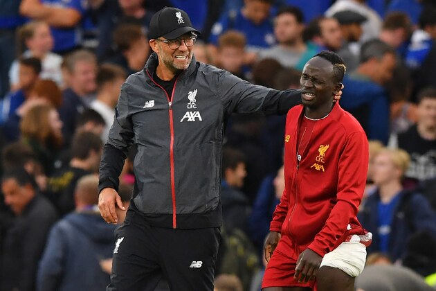 Liverpool's German manager Jurgen Klopp (L) gestures to Liverpool's Senegalese striker Sadio Mane (R) on the pitch after the English Premier League football match between Chelsea and Liverpool at Stamford Bridge in London on September 22, 2019. - Liverpool won the game 2-1. (Photo by OLLY GREENWOOD / AFP) / RESTRICTED TO EDITORIAL USE. No use with unauthorized audio, video, data, fixture lists, club/league logos or 'live' services. Online in-match use limited to 120 images. An additional 40 images may be used in extra time. No video emulation. Social media in-match use limited to 120 images. An additional 40 images may be used in extra time. No use in betting publications, games or single club/league/player publications. /         (Photo credit should read OLLY GREENWOOD/AFP/Getty Images)