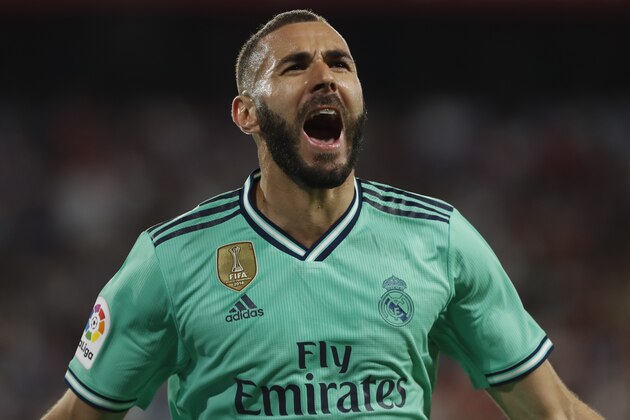 Real Madrid's Karim Benzema celebrates after scoring his side's opening goal during the Spanish La Liga soccer match between Sevilla and Real Madrid at the Ramon Sanchez Pizjuan stadium in Seville, Spain, Sunday, Sept. 22, 2019. (AP Photo/Miguel Morenatti)