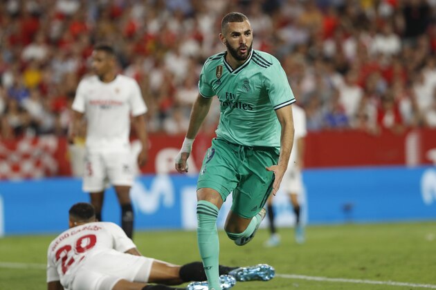 Real Madrid's Karim Benzema celebrates after scoring his side's opening goal during the Spanish La Liga soccer match between Sevilla and Real Madrid at the Ramon Sanchez Pizjuan stadium in Seville, Spain, Sunday, Sept. 22, 2019. (AP Photo/Miguel Morenatti)