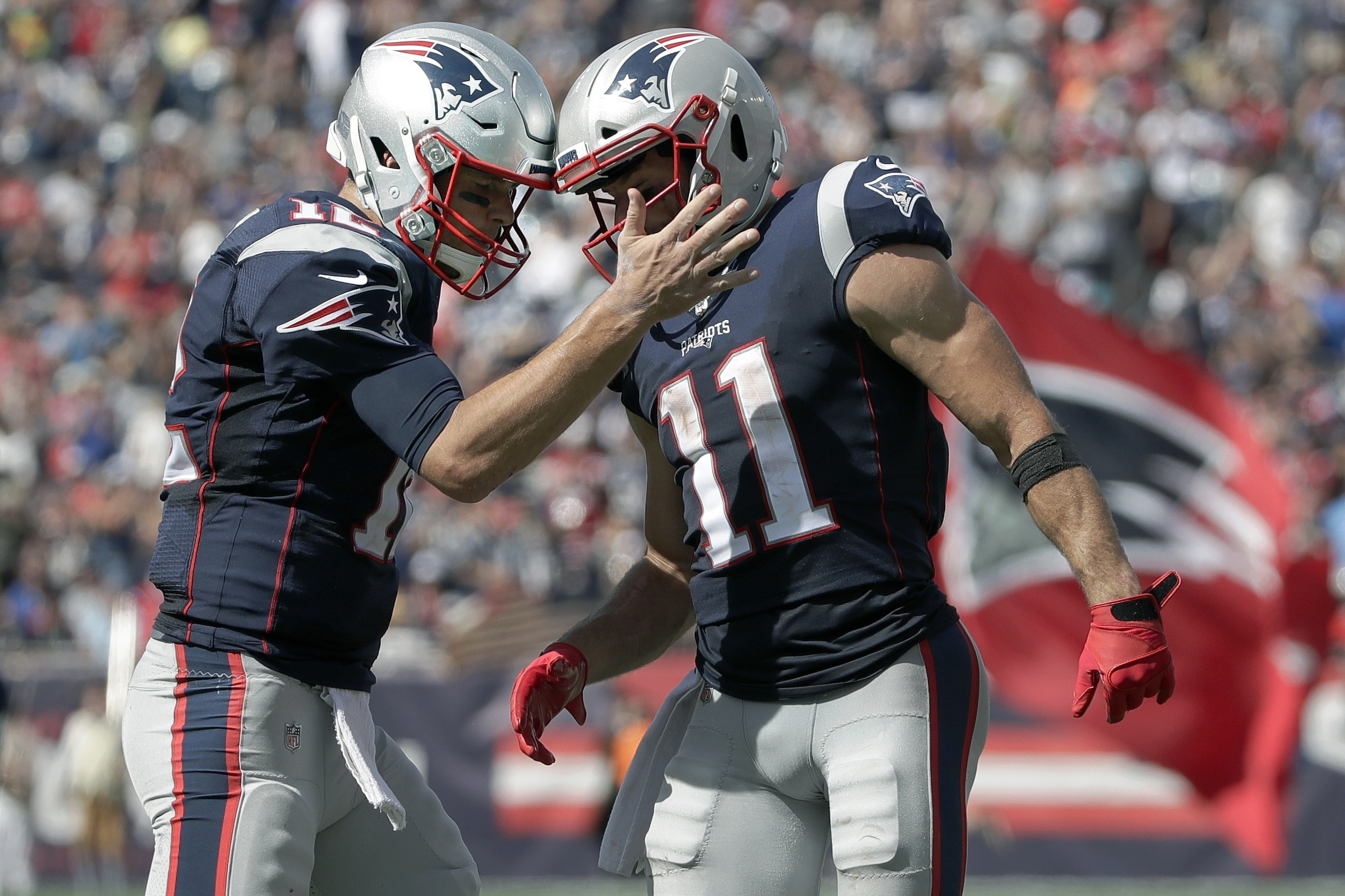 New England Patriots quarterback Tom Brady, left, celebrates his touchdown pass to Julian Edelman, right, in the first half of an NFL football game against the New York Jets, Sunday, Sept. 22, 2019, in Foxborough, Mass. (AP Photo/Elise Amendola)
