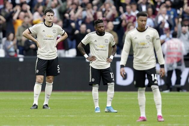 LONDON, ENGLAND - SEPTEMBER 22: Fred (C) of Manchester United looks dejected with Harry Maguire (L) of Manchester United after West Ham's second goal during the Premier League match between West Ham United and Manchester United at London Stadium on September 22, 2019 in London, United Kingdom. (Photo by Henry Browne/Getty Images)