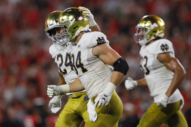 ATHENS, GEORGIA - SEPTEMBER 21: Cole Kmet #84 of the Notre Dame Fighting Irish celebrates his second quarter touchdown with Tommy Tremble #24 while playing the Georgia Bulldogs at Sanford Stadium on September 21, 2019 in Athens, Georgia. (Photo by Kevin C. Cox/Getty Images)