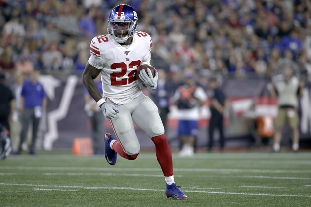 New York Giants running back Wayne Gallman carries the ball in the first half of an NFL preseason football game against the New England Patriots, Thursday, Aug. 29, 2019, in Foxborough, Mass. (AP Photo/Elise Amendola)