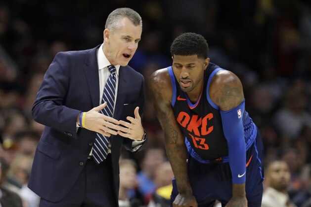 Oklahoma City Thunder coach Billy Donovan talks with Paul George during the second half of the team's NBA basketball game against the Cleveland Cavaliers, Wednesday, Nov. 7, 2018, in Cleveland. The Thunder won 95-86. (AP Photo/Tony Dejak)