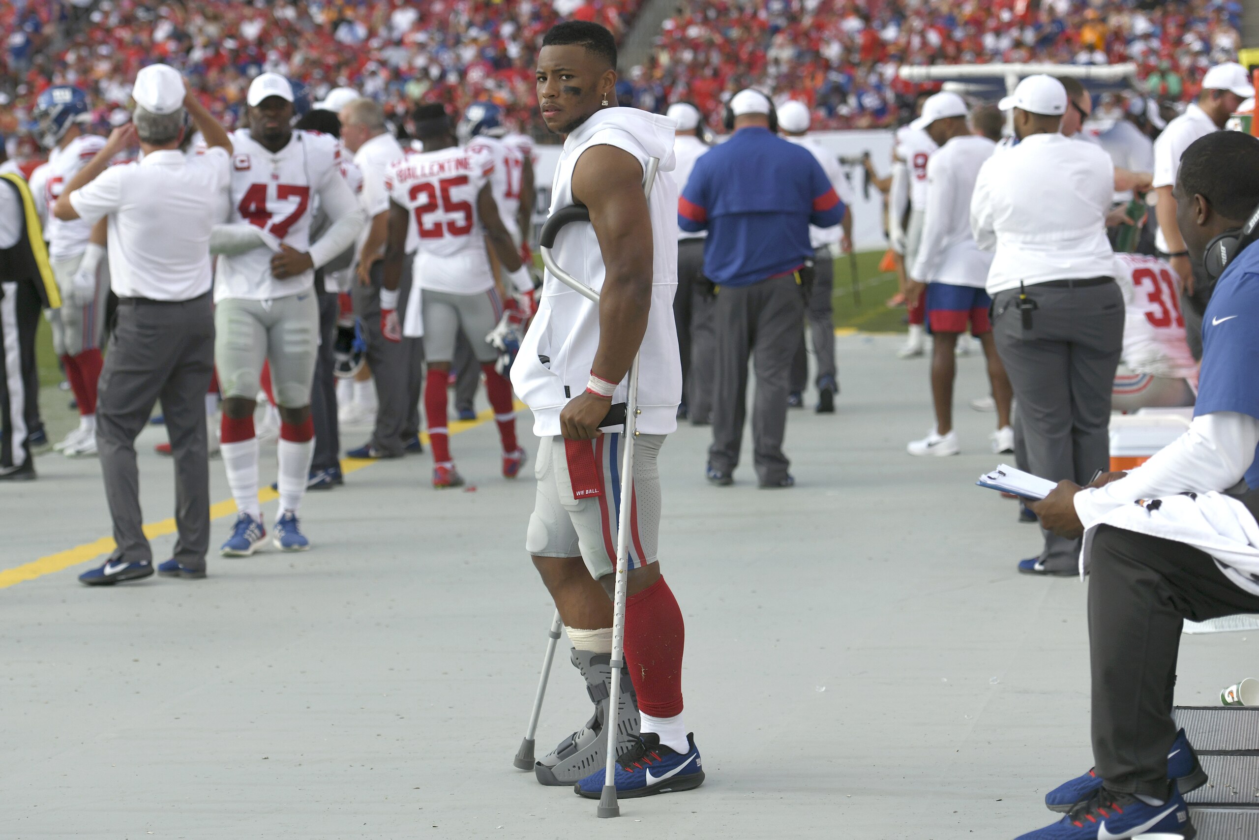 New York Giants running back Saquon Barkley stands on crutches in the bench area after getting injured against the Tampa Bay Buccaneers during the first half of an NFL football game Sunday, Sept. 22, 2019, in Tampa, Fla. (AP Photo/Jason Behnken)