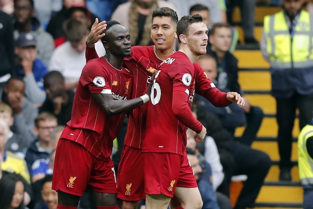 Liverpool's Roberto Firmino, center, celebrates with teammates Sadio Mane, left, and Andrew Robertson after scoring his side's second goal during the British Premier League soccer match between Chelsea and Liverpool, at the Stamford Bridge Stadium, London, Sunday, Sept. 22, 2019. (AP Photo/Frank Augstein) Liverpool's Roberto Firmino, center, celebrates with teammates Sadio Mane, left, and Andrew Robertson after scoring his side's second goal during the British Premier League soccer match between Chelsea and Liverpool, at the Stamford Bridge Stadium, London, Sunday, Sept. 22, 2019. (AP Photo/Frank Augstein)