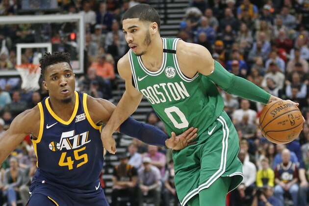 Utah Jazz guard Donovan Mitchell (45) guards Boston Celtics forward Jayson Tatum (0) as he drives in the second half during an NBA basketball game Wednesday, March 28, 2018, in Salt Lake City. (AP Photo/Rick Bowmer)