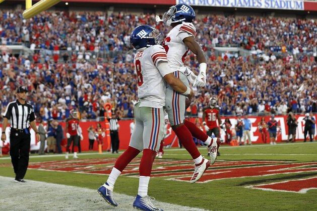 New York Giants quarterback Daniel Jones (8) celebrates his touchdown run against the Tampa Bay Buccaneers with wide receiver Darius Slayton (86) during the second half of an NFL football game Sunday, Sept. 22, 2019, in Tampa, Fla. (AP Photo/Mark LoMoglio)