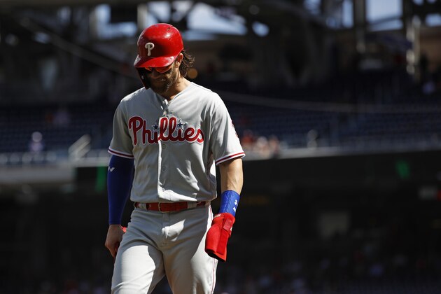 Philadelphia Phillies' Bryce Harper walks off the field in the first inning of the first baseball game of a doubleheader against the Washington Nationals, Tuesday, Sept. 24, 2019, in Washington. (AP Photo/Patrick Semansky)
